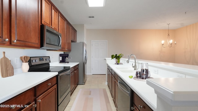 kitchen with visible vents, light countertops, a sink, and stainless steel appliances