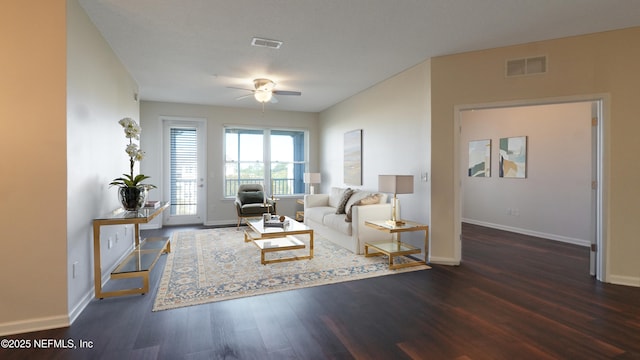 living area with baseboards, ceiling fan, visible vents, and wood finished floors