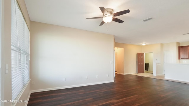 unfurnished room featuring wood finished floors, visible vents, baseboards, and ceiling fan