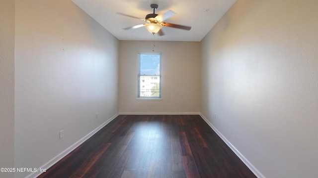 empty room with dark wood-style floors, baseboards, and a ceiling fan