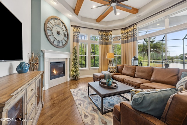 464 Deer Valley Dr, Ponte Vedra, FL 32081 - living room featuring beamed ceiling, ceiling fan, wood finished floors, a tiled fireplace, and coffered ceiling