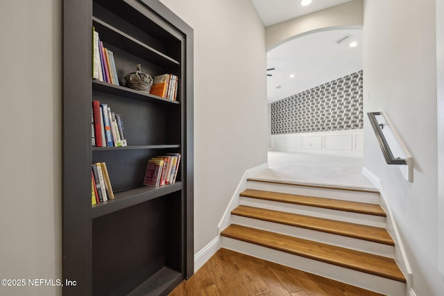 464 Deer Valley Dr, Ponte Vedra, FL 32081 - staircase with built in shelves, wood finished floors, baseboards, arched walkways, and recessed lighting