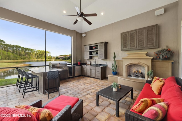 464 Deer Valley Dr, Ponte Vedra, FL 32081 - living room featuring a water view, a tile fireplace, recessed lighting, a ceiling fan, and brick floor