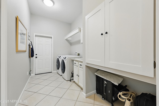 laundry room featuring light tile patterned floors, cabinet space, baseboards, and separate washer and dryer