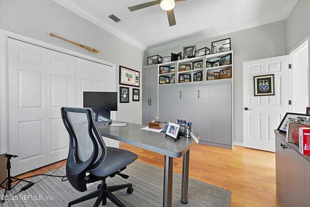 office area with visible vents, ornamental molding, light wood finished floors, and ceiling fan