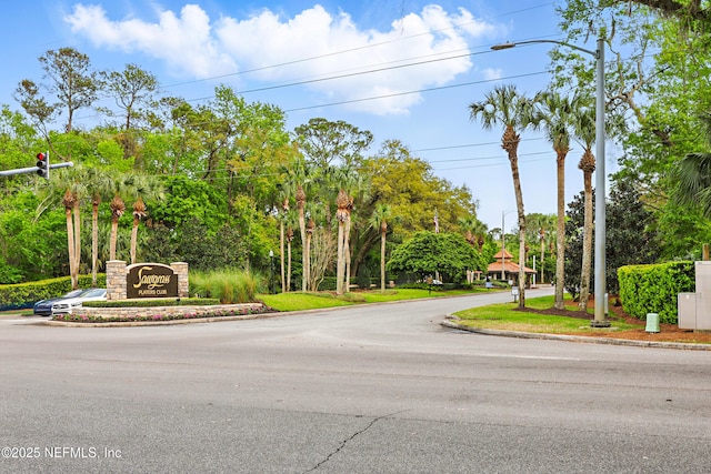 view of street featuring street lighting and curbs