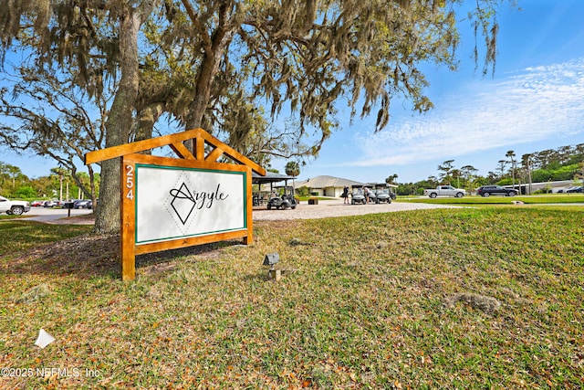 community / neighborhood sign with a lawn