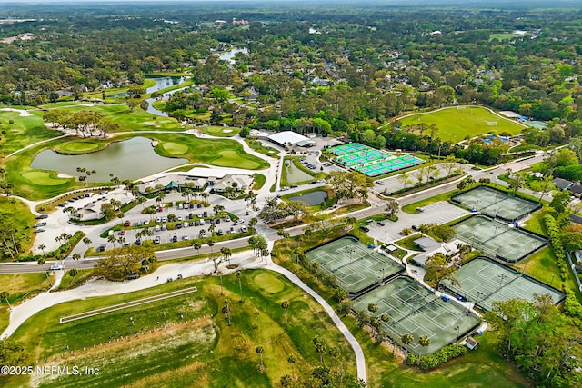 birds eye view of property with view of golf course and a water view