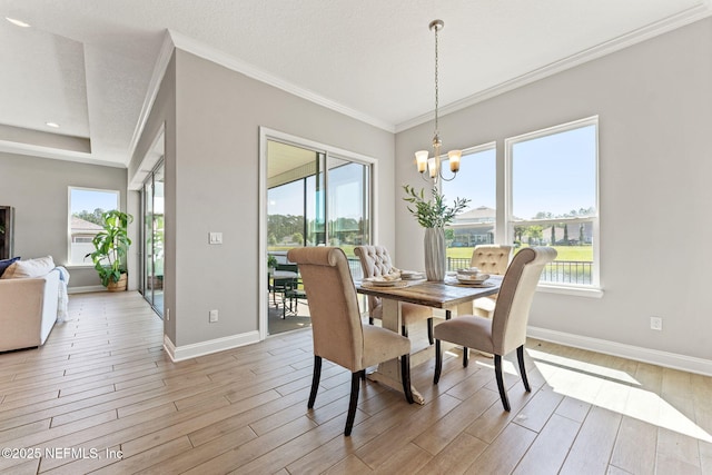 dining space with light wood-type flooring, a wealth of natural light, baseboards, and a notable chandelier