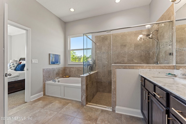 ensuite bathroom featuring a tile shower, vanity, ensuite bath, baseboards, and a garden tub