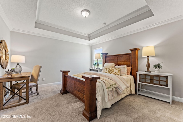 carpeted bedroom with a tray ceiling, a textured ceiling, baseboards, and ornamental molding