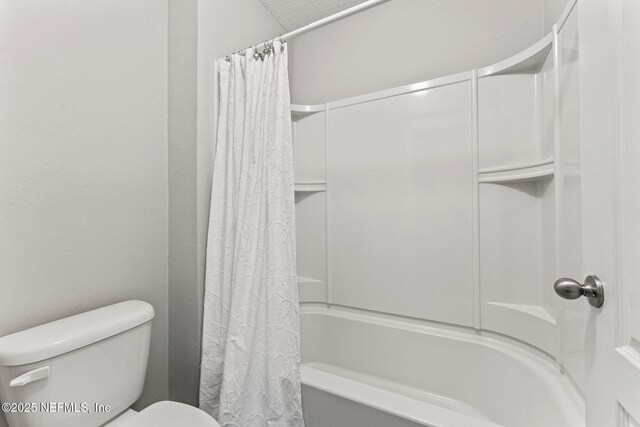 full bathroom featuring toilet and shower / bath combination with curtain