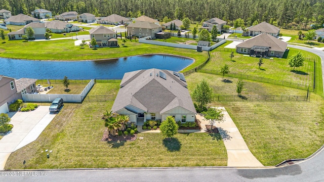 drone / aerial view with a residential view and a water view