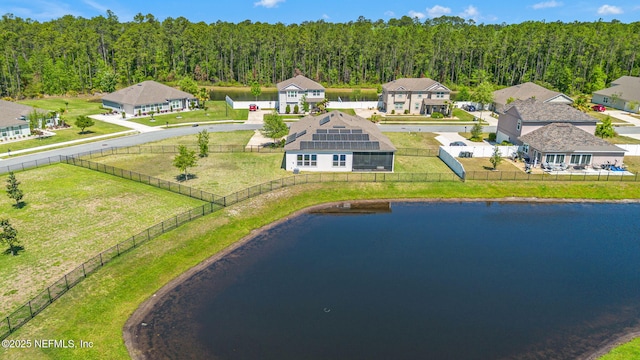 birds eye view of property featuring a wooded view, a residential view, and a water view
