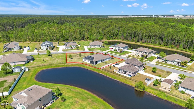 bird's eye view with a residential view, a wooded view, and a water view