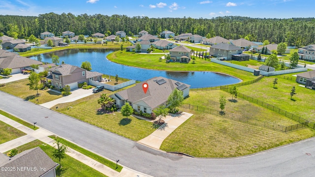 bird's eye view with a view of trees, a water view, and a residential view
