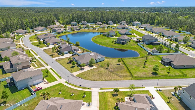 bird's eye view with a forest view, a residential view, and a water view