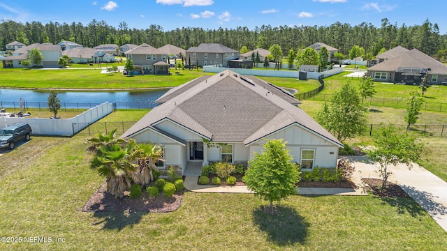drone / aerial view featuring a water view and a residential view