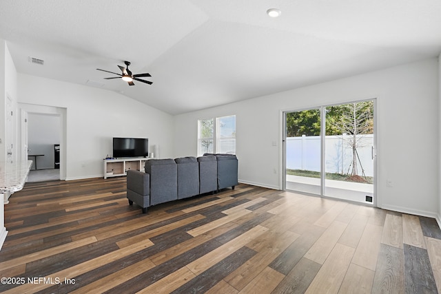 6387 Barrington Cv Ln, Jacksonville, FL 32218 - unfurnished living room featuring wood finished floors, vaulted ceiling, a ceiling fan, and baseboards