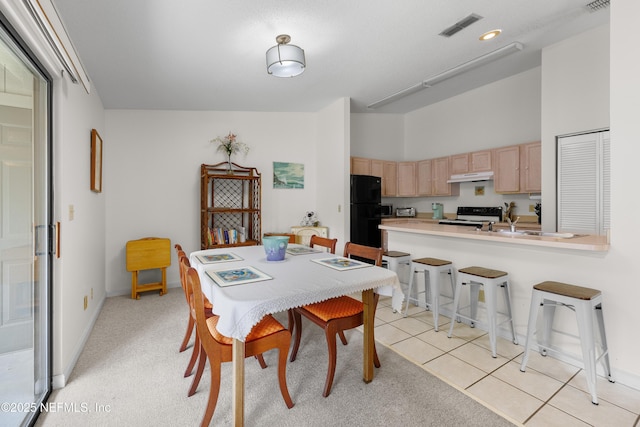 38 Talavera Ct, Saint Augustine, FL 32086 - dining room featuring visible vents, light carpet, a high ceiling, light tile patterned flooring, and baseboards