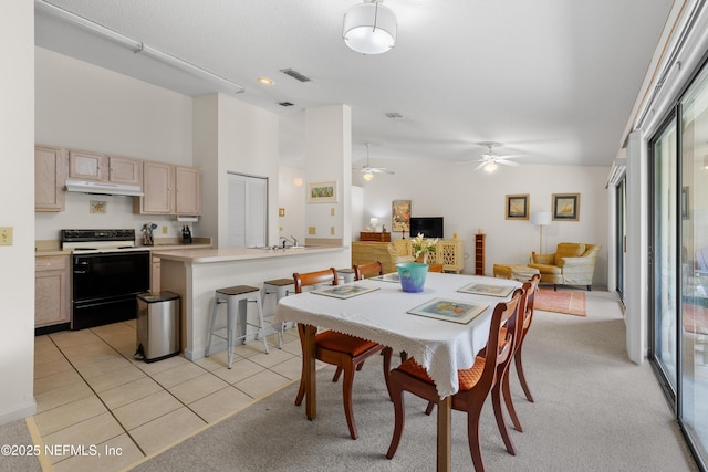 38 Talavera Ct, Saint Augustine, FL 32086 - dining room with light carpet, light tile patterned flooring, visible vents, ceiling fan, and high vaulted ceiling