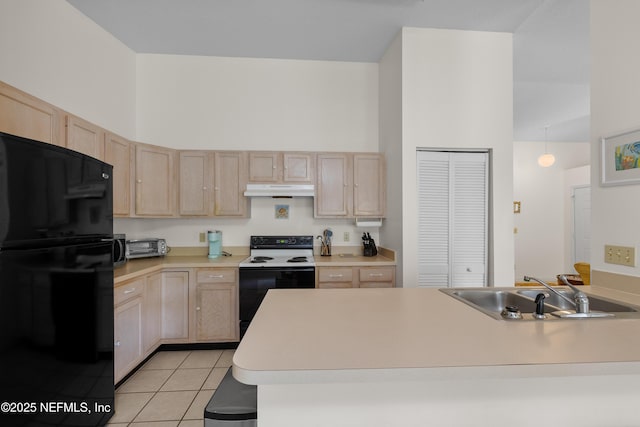38 Talavera Ct, Saint Augustine, FL 32086 - kitchen with freestanding refrigerator, light brown cabinetry, under cabinet range hood, a sink, and electric range oven