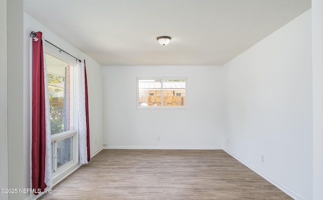 4880 Brighton Dr, Jacksonville, FL 32217 - unfurnished room featuring a healthy amount of sunlight and wood finished floors