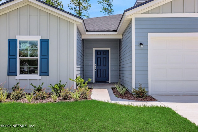 356 Salazar St, Saint Augustine, FL 32095 - view of exterior entry with board and batten siding, a garage, roof with shingles, and a lawn