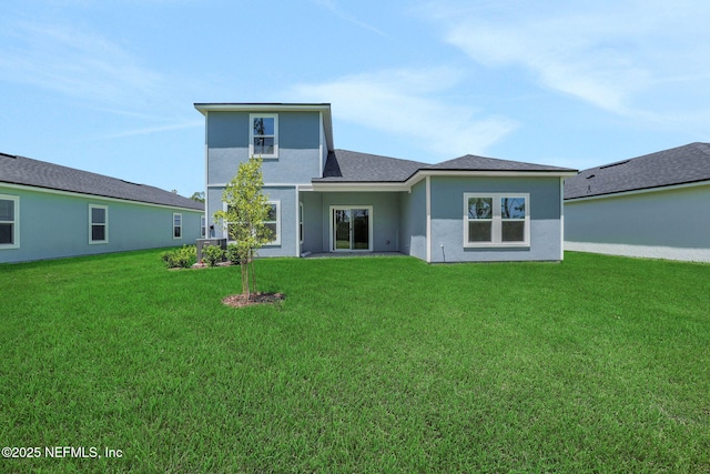 356 Salazar St, Saint Augustine, FL 32095 - rear view of property featuring a lawn, stucco siding, and a shingled roof
