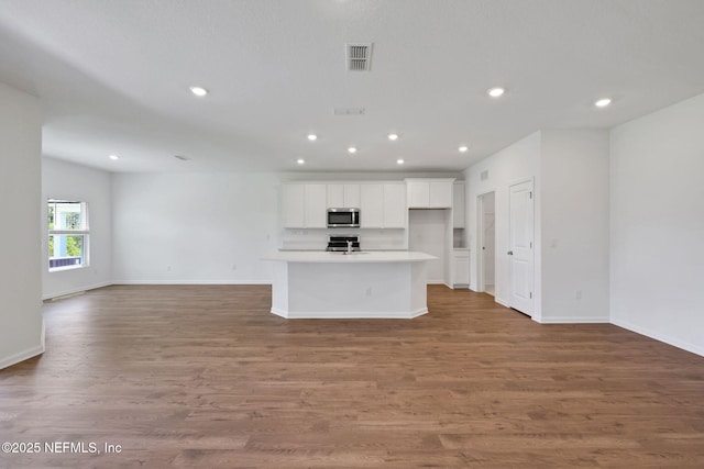 356 Salazar St, Saint Augustine, FL 32095 - kitchen featuring stainless steel microwave, open floor plan, stove, white cabinetry, and recessed lighting