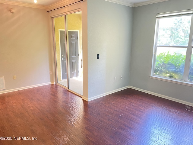 8539 Gate Pkwy W Unit 1616, Jacksonville, FL 32216 - spare room with baseboards, dark wood-style flooring, and ornamental molding