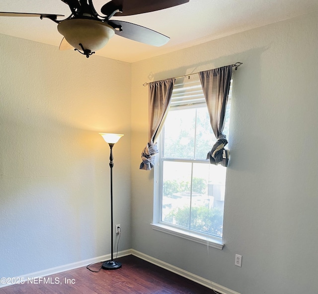 8539 Gate Pkwy W Unit 1616, Jacksonville, FL 32216 - unfurnished room with dark wood-type flooring, ceiling fan, and baseboards