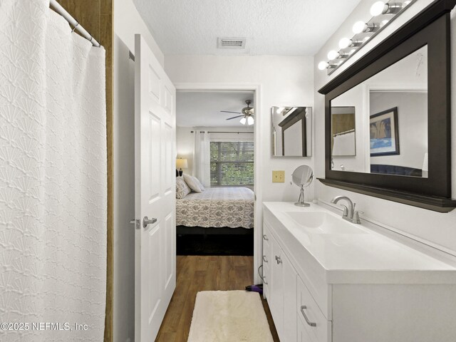 35211 Harbour Vista Cir, Saint Augustine, FL 32080 - ensuite bathroom with vanity, ensuite bath, a ceiling fan, visible vents, and wood finished floors