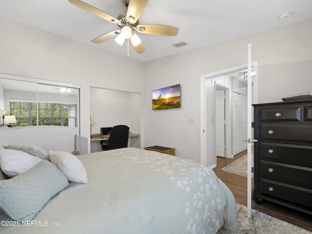 35211 Harbour Vista Cir, Saint Augustine, FL 32080 - bedroom with wood finished floors, a ceiling fan, visible vents, and multiple closets