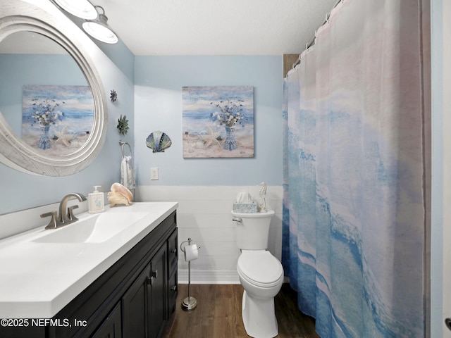 35211 Harbour Vista Cir, Saint Augustine, FL 32080 - bathroom with toilet, wainscoting, wood finished floors, and vanity