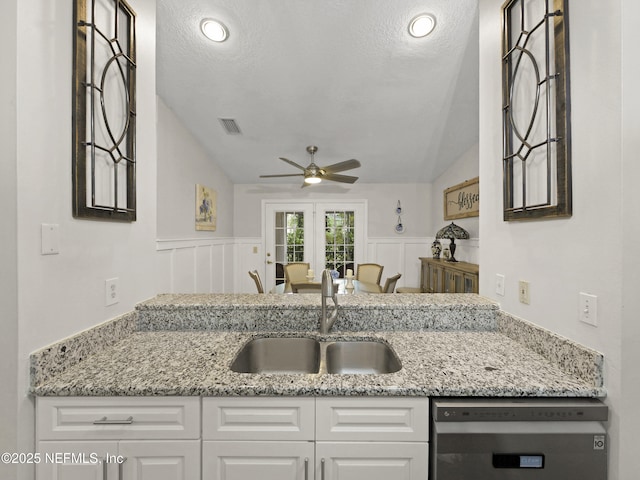 35211 Harbour Vista Cir, Saint Augustine, FL 32080 - kitchen with white cabinets, ceiling fan, a sink, and vaulted ceiling