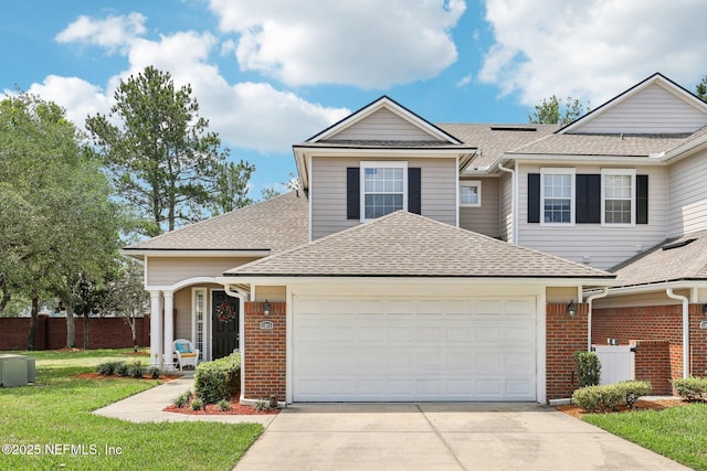 2011 Pond Ridge Ct Unit 1201, Fleming Island, FL 32003 - traditional home with a garage, a shingled roof, concrete driveway, brick siding, and roof mounted solar panels