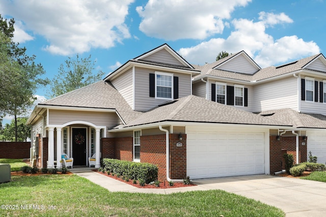 2011 Pond Ridge Ct Unit 1201, Fleming Island, FL 32003 - traditional-style home featuring a garage, brick siding, a shingled roof, and concrete driveway