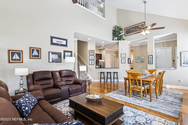 2011 Pond Ridge Ct Unit 1201, Fleming Island, FL 32003 - living area with wood finished floors, stairway, ceiling fan, baseboards, and a towering ceiling