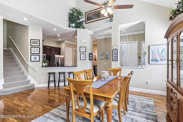 2011 Pond Ridge Ct Unit 1201, Fleming Island, FL 32003 - dining space with wood finished floors, stairway, ceiling fan, baseboards, and a towering ceiling