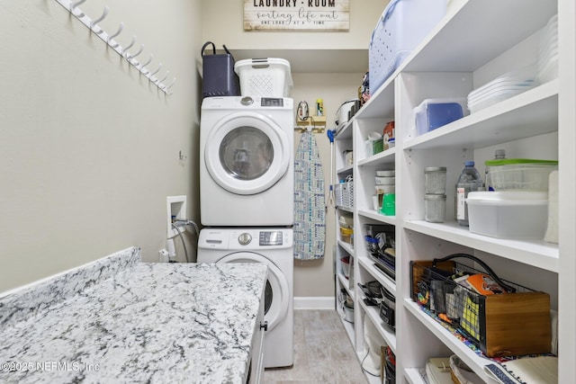 2011 Pond Ridge Ct Unit 1201, Fleming Island, FL 32003 - laundry area with estacked washer and dryer, wood finished floors, and baseboards
