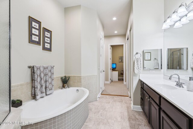 2011 Pond Ridge Ct Unit 1201, Fleming Island, FL 32003 - bathroom with vanity, a garden tub, and recessed lighting