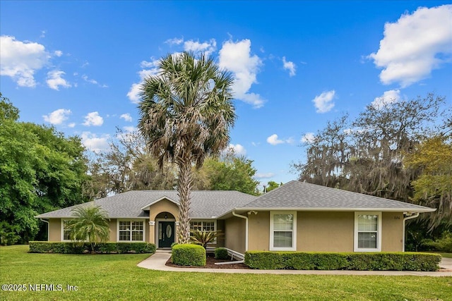 226 Crystal Cove Dr, Palatka, FL 32177 - ranch-style house with a front yard, stucco siding, and roof with shingles