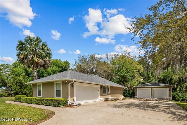 226 Crystal Cove Dr, Palatka, FL 32177 - single story home with stucco siding, a detached garage, and an outdoor structure