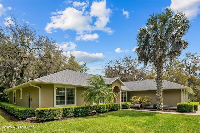 226 Crystal Cove Dr, Palatka, FL 32177 - ranch-style home with a front lawn, stucco siding, and roof with shingles