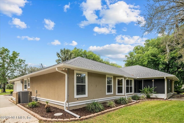 226 Crystal Cove Dr, Palatka, FL 32177 - view of front of house featuring a sunroom, stucco siding, roof with shingles, an attached garage, and a front yard