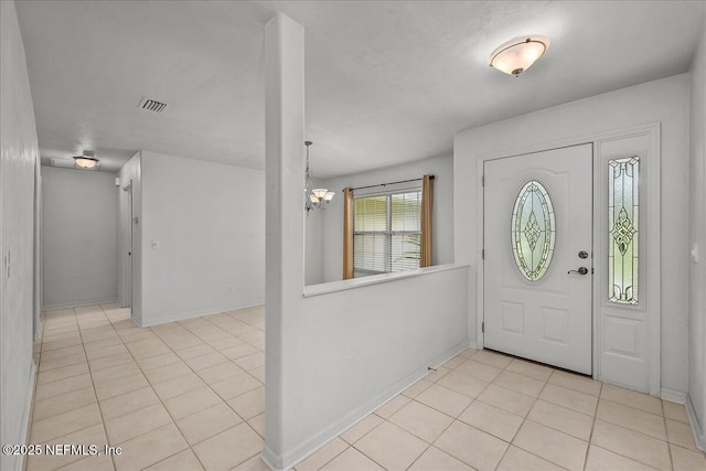 226 Crystal Cove Dr, Palatka, FL 32177 - entryway featuring baseboards, visible vents, a notable chandelier, and light tile patterned floors