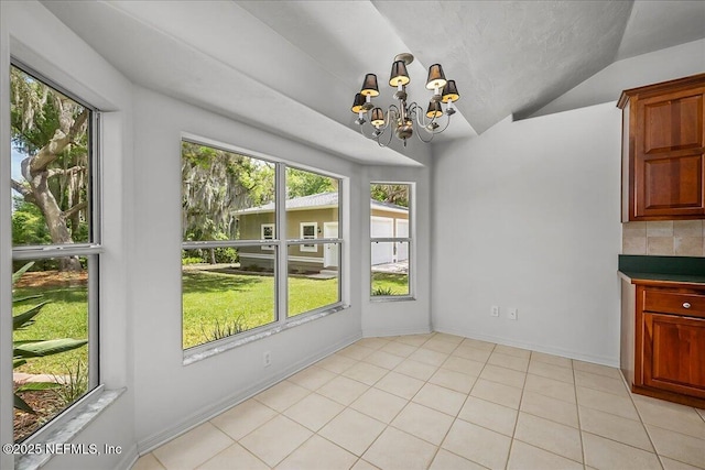 226 Crystal Cove Dr, Palatka, FL 32177 - unfurnished dining area featuring baseboards, a notable chandelier, light tile patterned floors, and vaulted ceiling