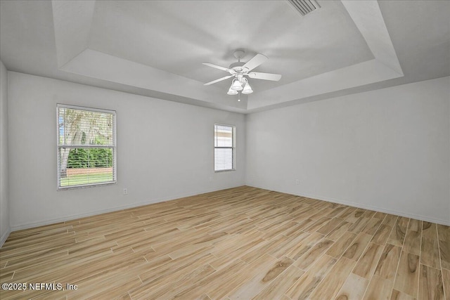 226 Crystal Cove Dr, Palatka, FL 32177 - spare room with ceiling fan, visible vents, light wood-style floors, and a raised ceiling