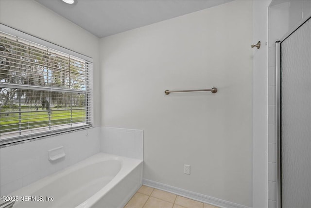 226 Crystal Cove Dr, Palatka, FL 32177 - bathroom featuring a garden tub, baseboards, tile patterned floors, and a shower stall